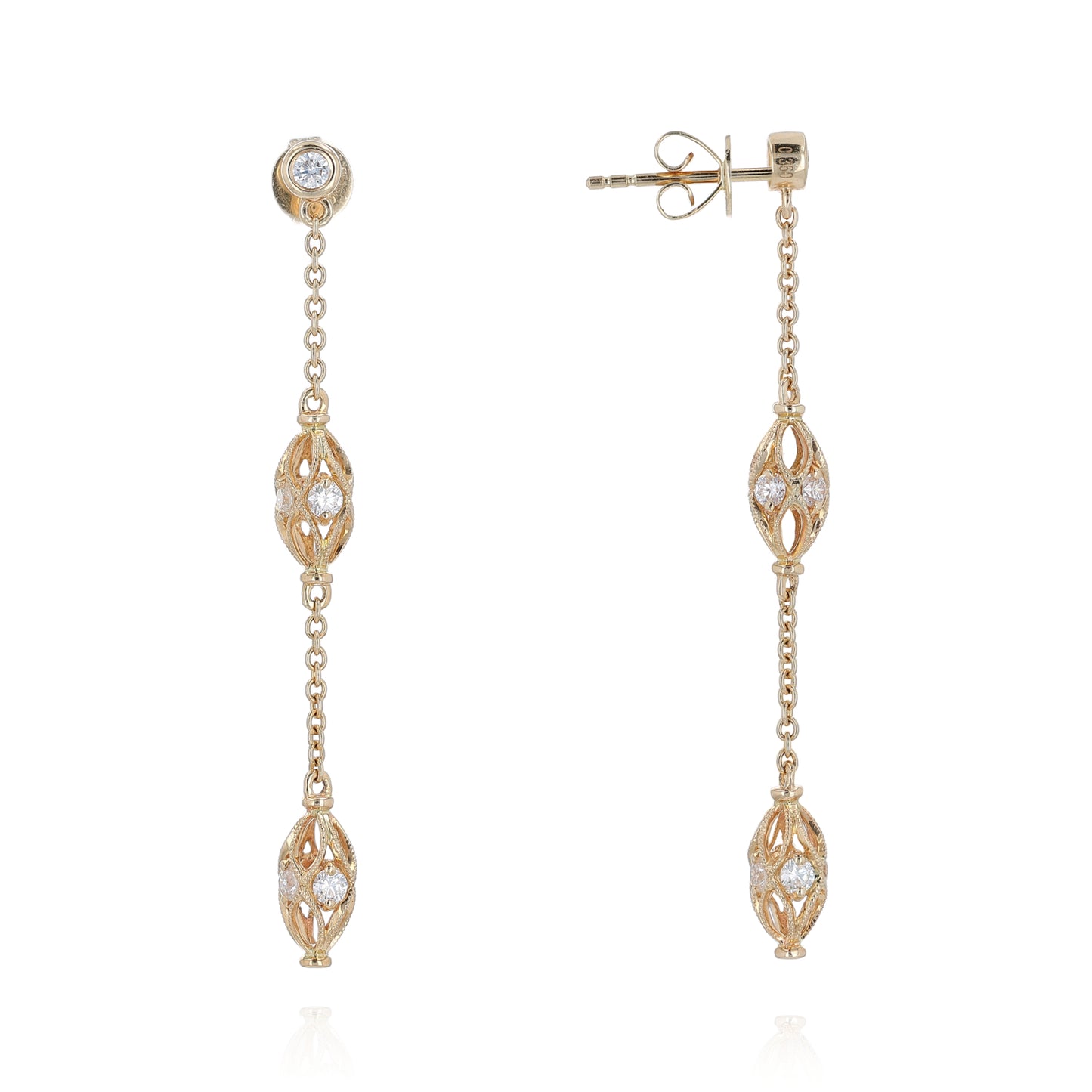 Gold dangle earrings with diamond accents on a white background