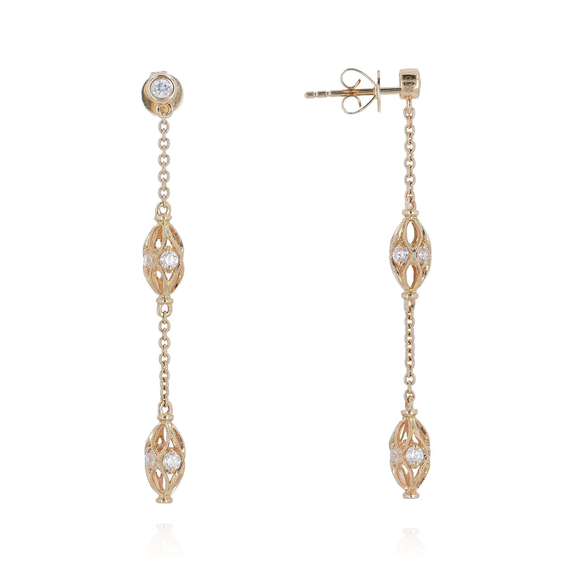 Gold dangle earrings with diamond accents on a white background