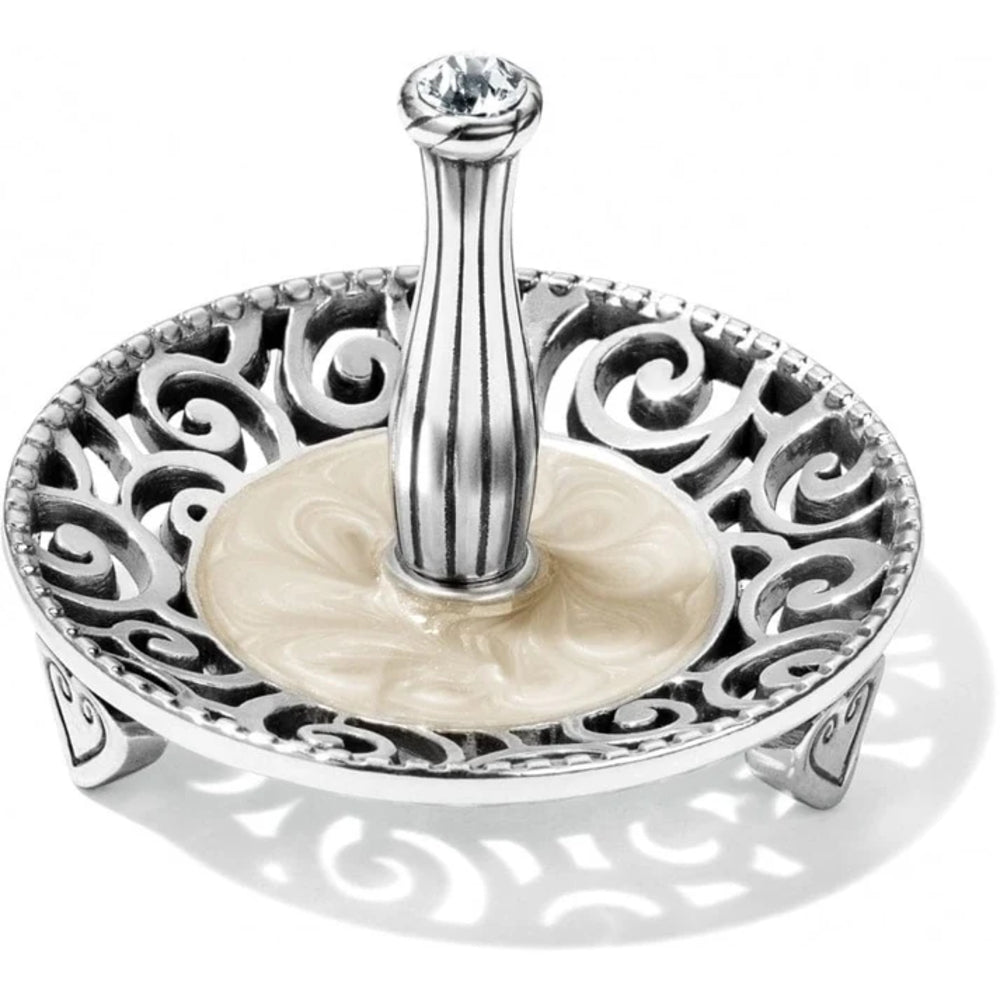 Silver ring holder with intricate designs on a white background