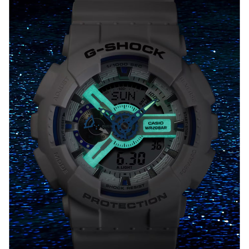 G-Shock watch with glowing face on a dark blue background
