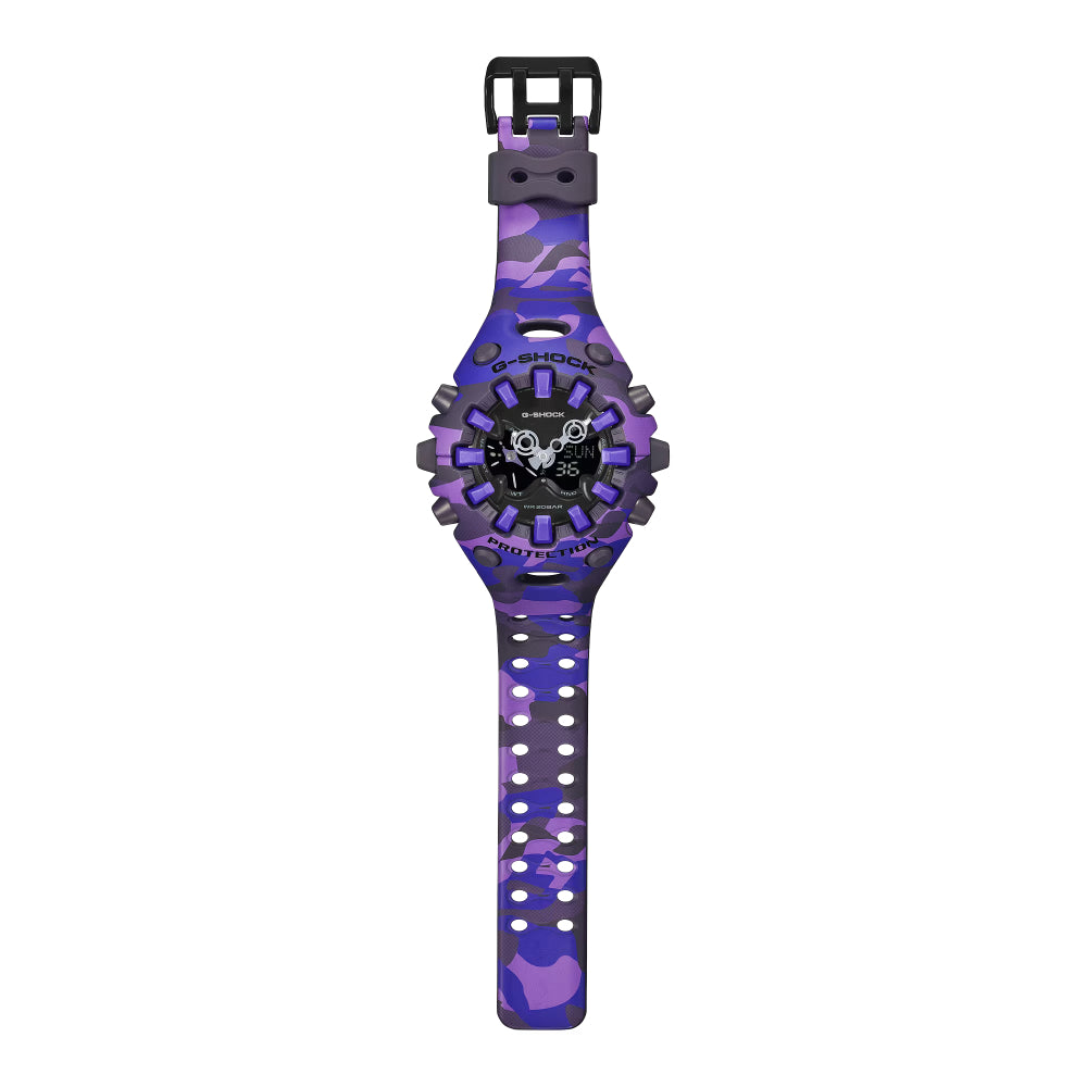 A kids' digital watch with a purple and black camouflage pattern on the strap and case, featuring a black dial with a skull graphic and a black buckle, shown against a plain white background.