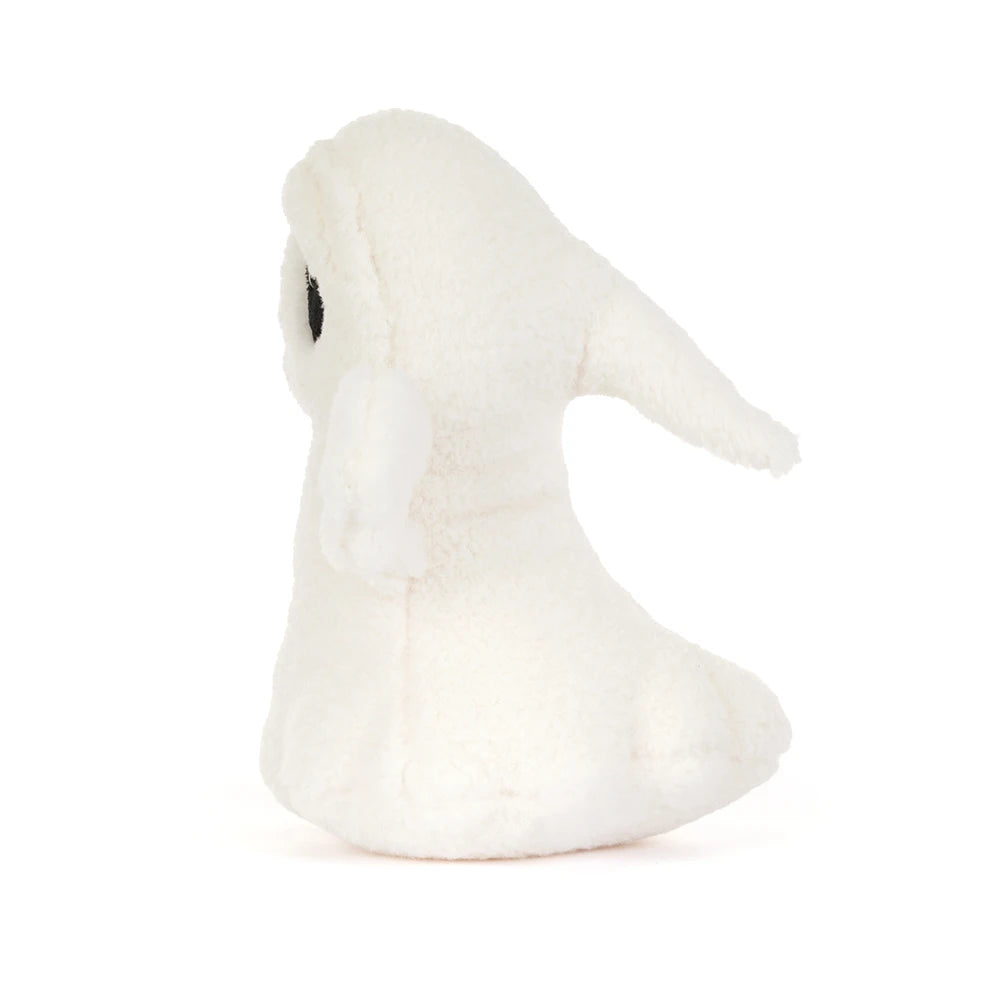 The side of a small white plush ghost toy with black embroidered eyes and a simple stitched smile, centered on a clean white background