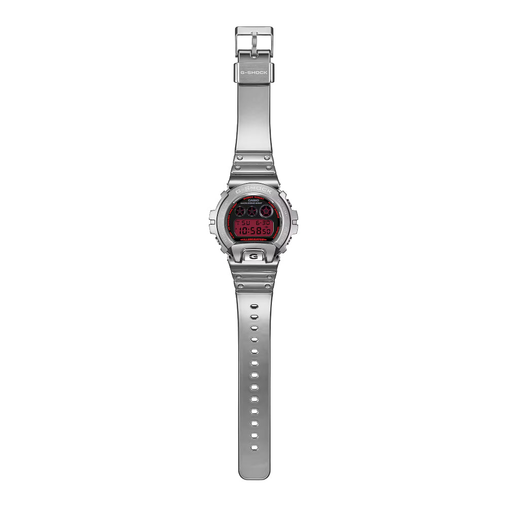 Silver G-Shock watch with a red analog/digital dial on a white background
