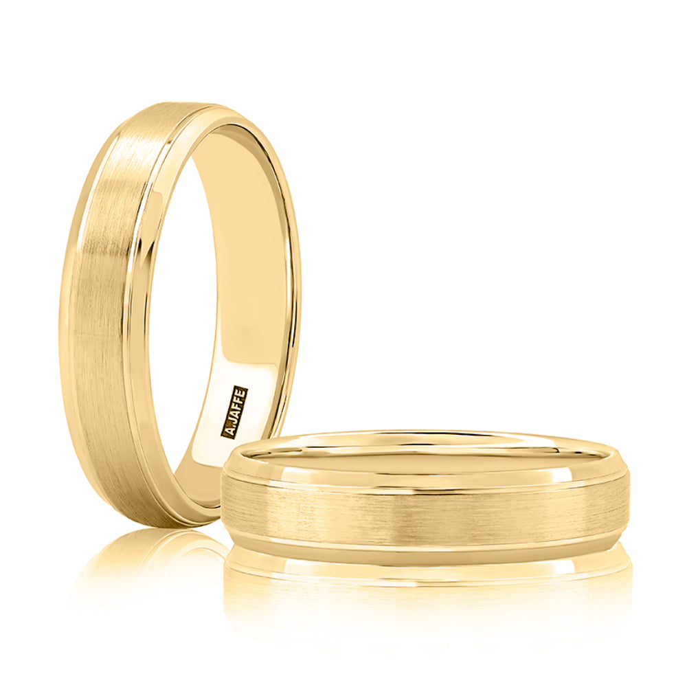 Two gold rings on a white background