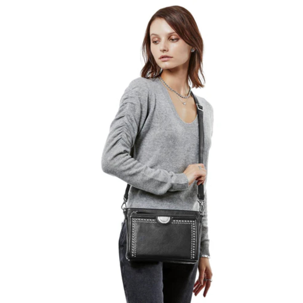 Woman wearing black leather crossbody bag