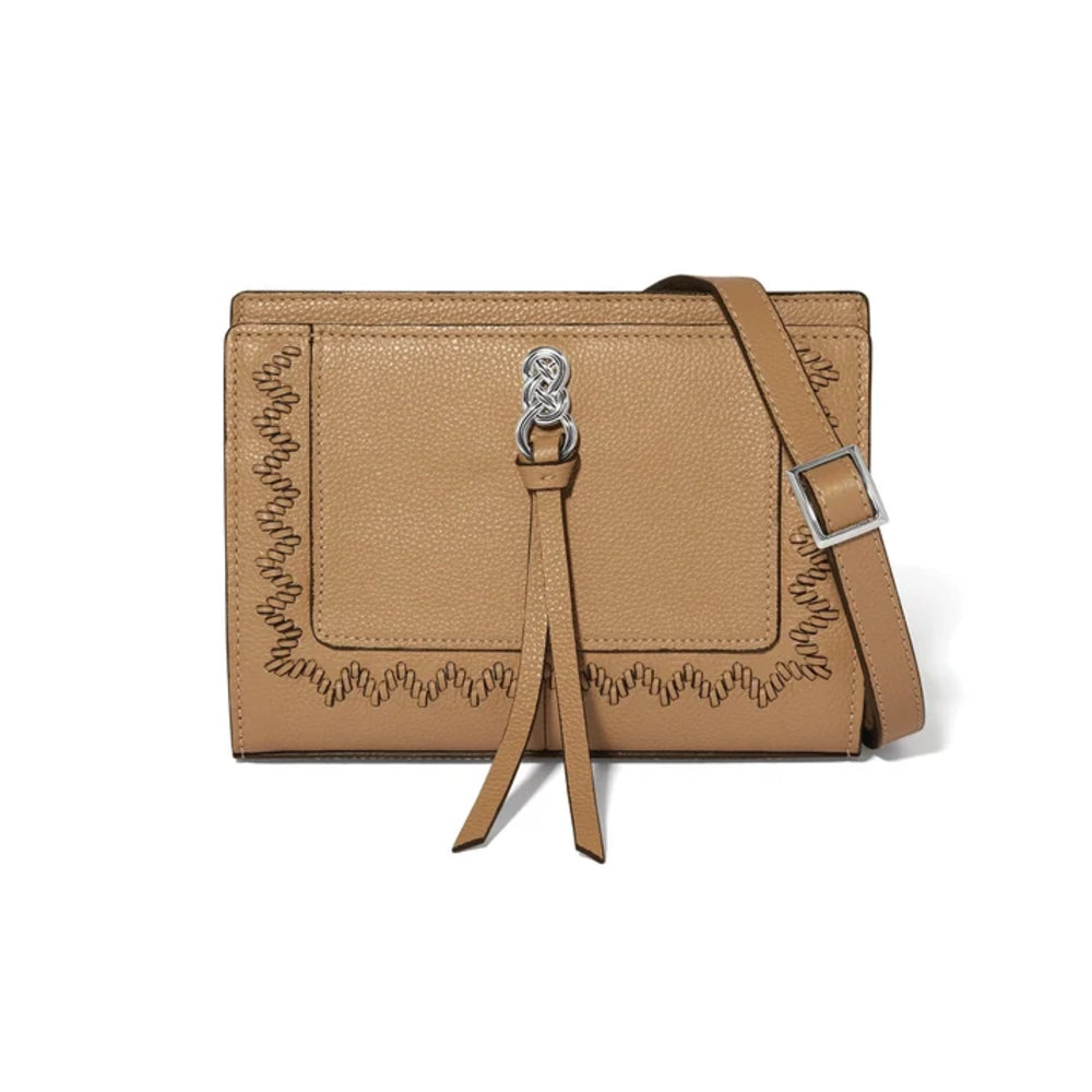 A tan pebbled leather crossbody bag with a decorative zigzag stitched border, a front flap with a tassel detail, and a silver-tone metal clasp, shown on a plain white background.