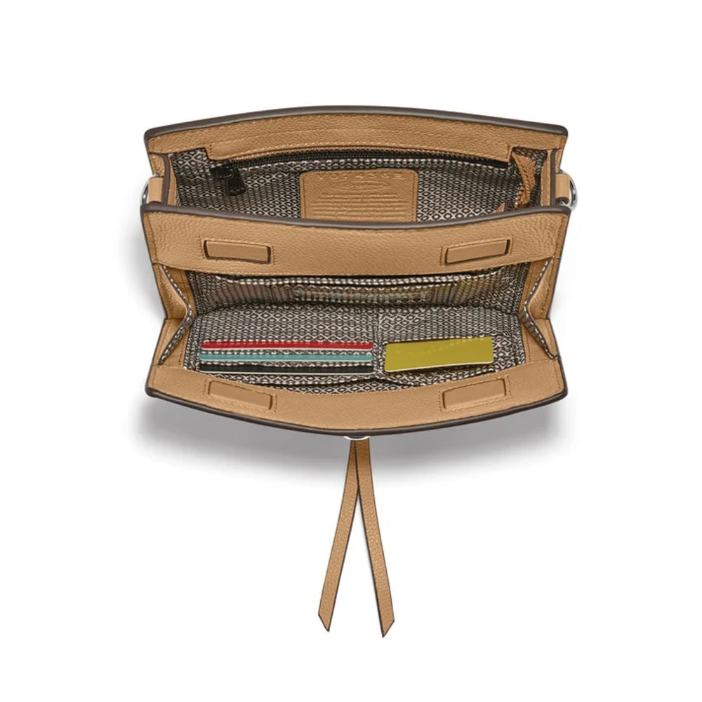The interior of a structured tan leather handbag with a woven black and tan patterned lining, shown open against a white background.