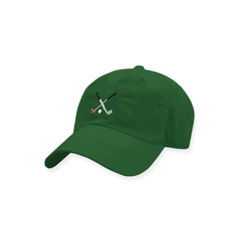 Green cap with embroidered design on a white background