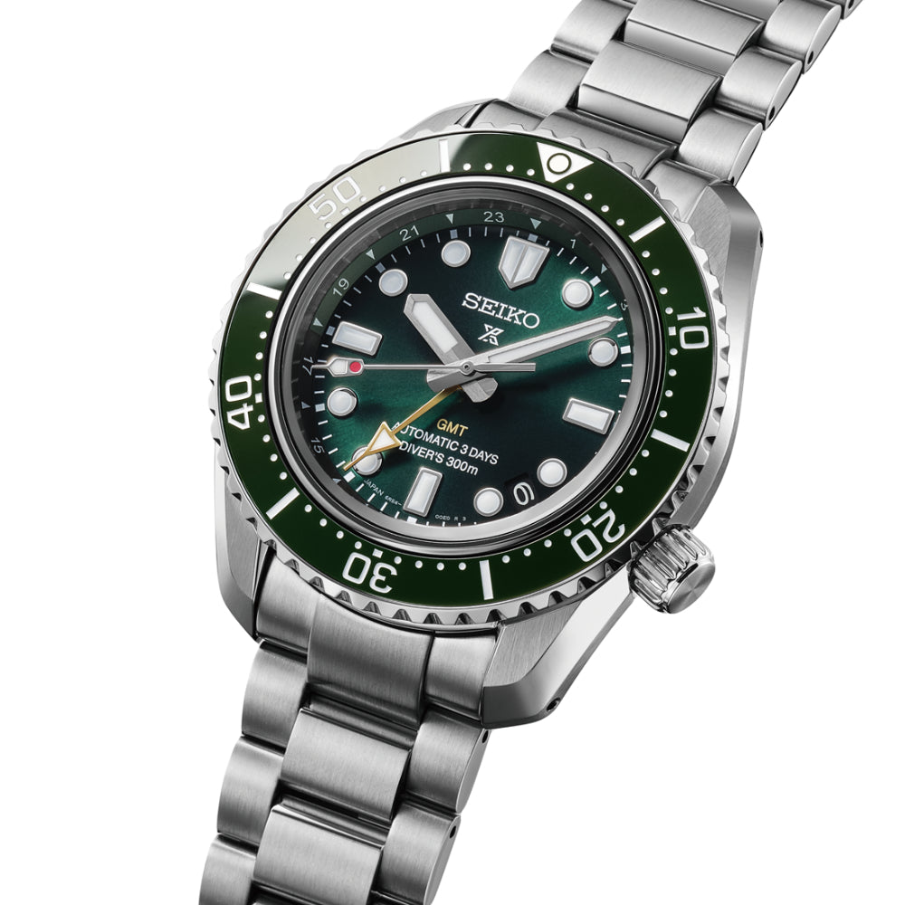 Seiko watch with green dial and silver metal bracelet on a white background