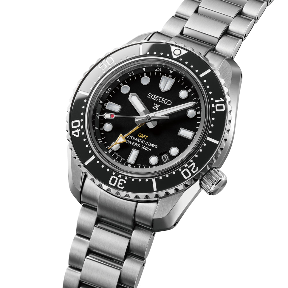 Seiko watch with black dial and silver metal bracelet on a white background