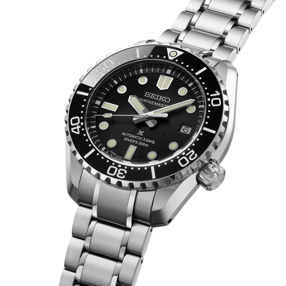 Seiko watch with black dial and silver metal bracelet on a white background