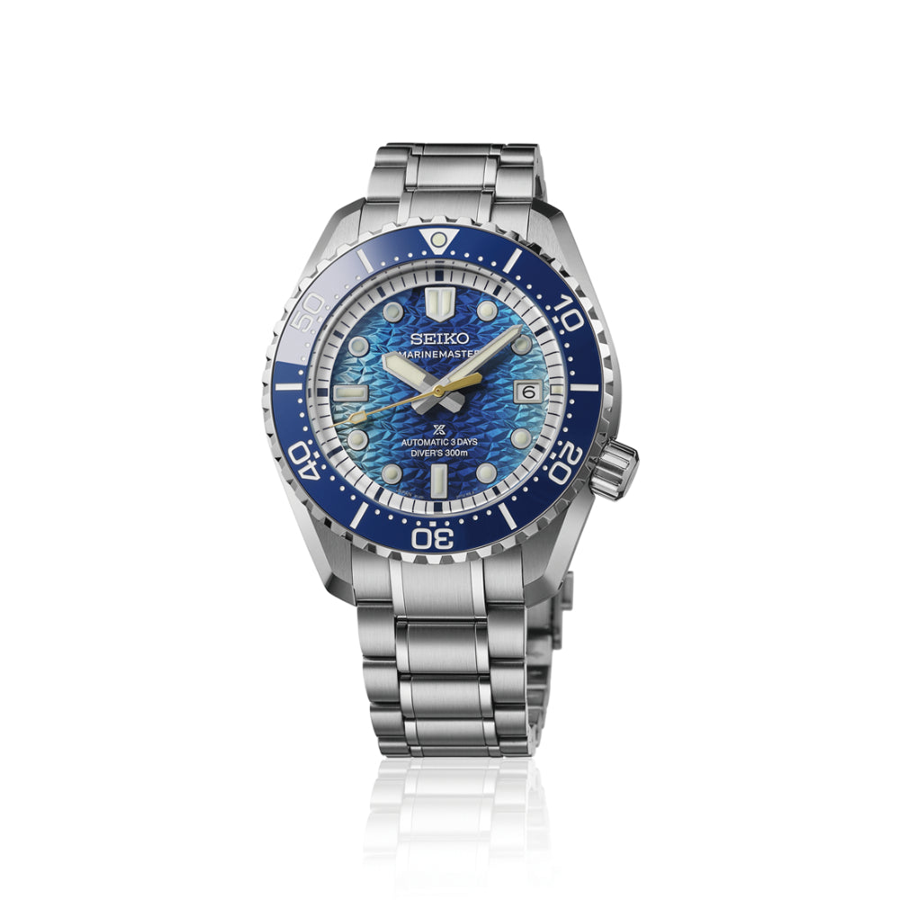 A Seiko Submariner watch with a stainless steel link bracelet, featuring a blue and white mother-of-pearl dial and a blue bezel, set against a plain white background with a subtle reflection.