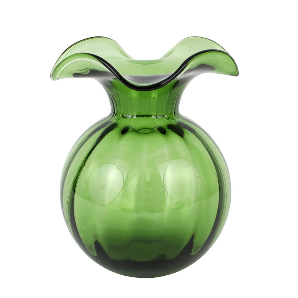 Green glass vase with wavy top on a white background.