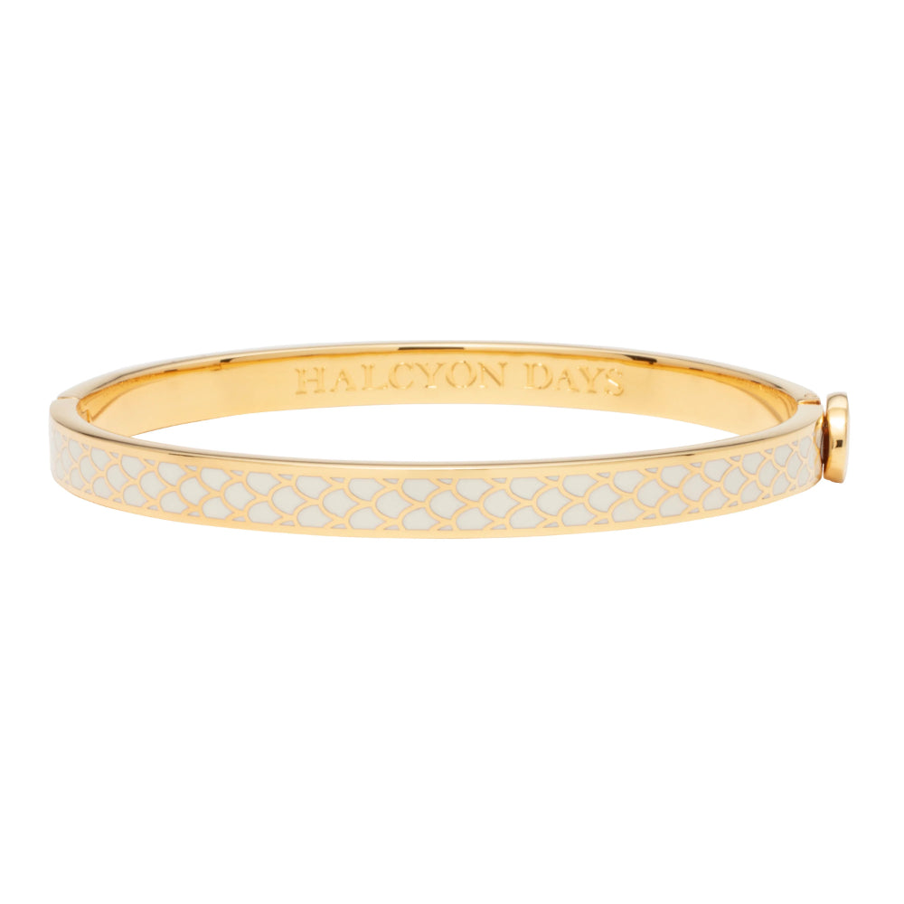 Gold bracelet with white pattern on a white background