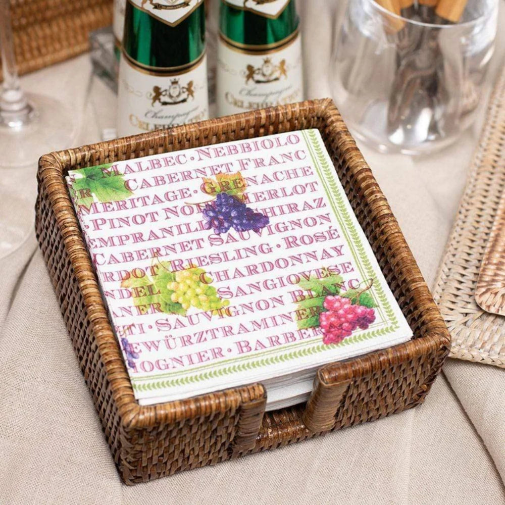 Wicker coaster set with a card displaying wine grape names and types on a table.