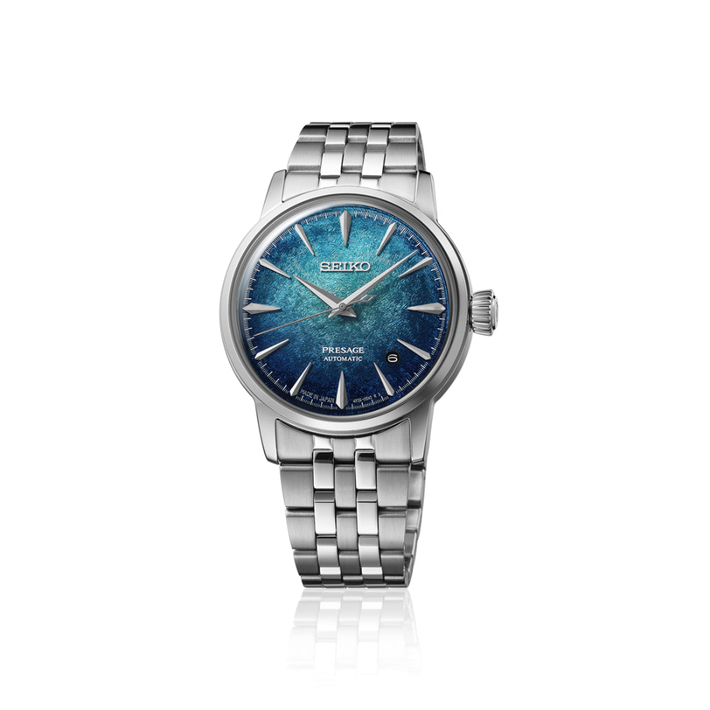 A Seiko Tissot Passio Automatic watch with a silver stainless steel link bracelet and a textured blue dial, shown on a clean white background with a subtle reflection.