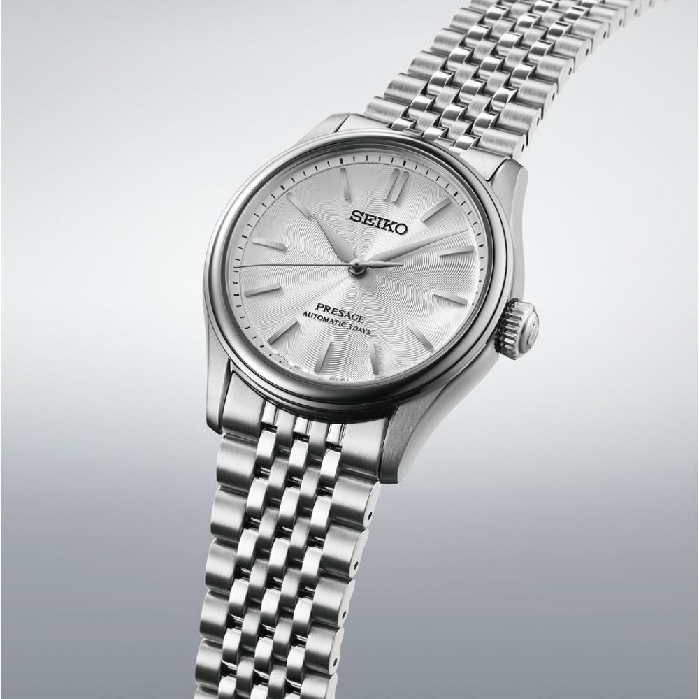 Silver Seiko watch with a detailed face on a light gray background