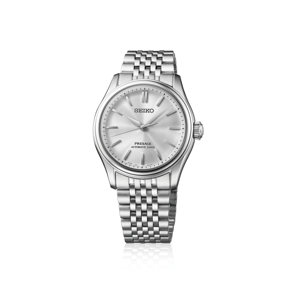 A Seiko Presage automatic watch with a silver stainless steel case and a matching silver link bracelet, featuring a textured silver dial with baton hour markers.