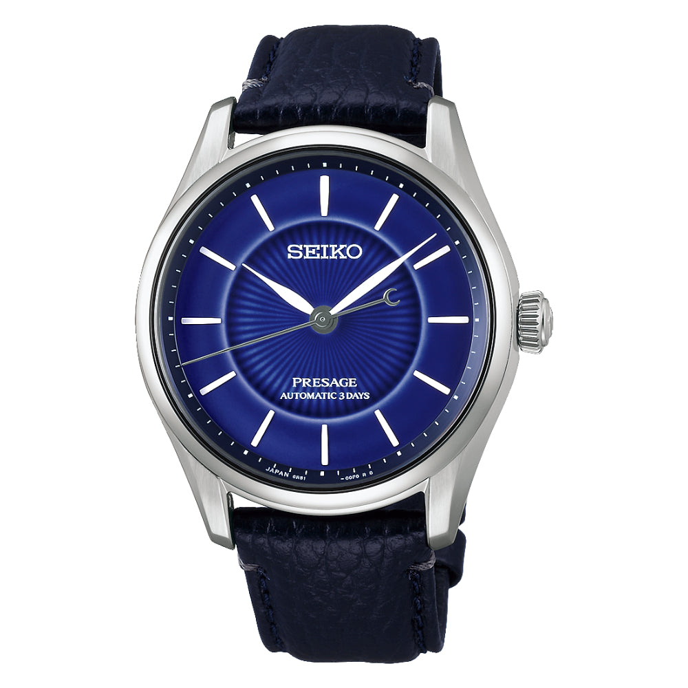 A Seiko wristwatch with a silver-tone stainless steel case, a deep blue sunburst dial, and a textured navy blue leather strap, shown against a plain white background.