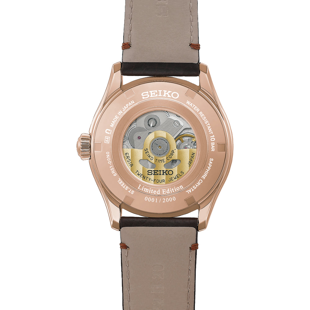 Seiko watch with rose gold case and beige leather strap on a white background