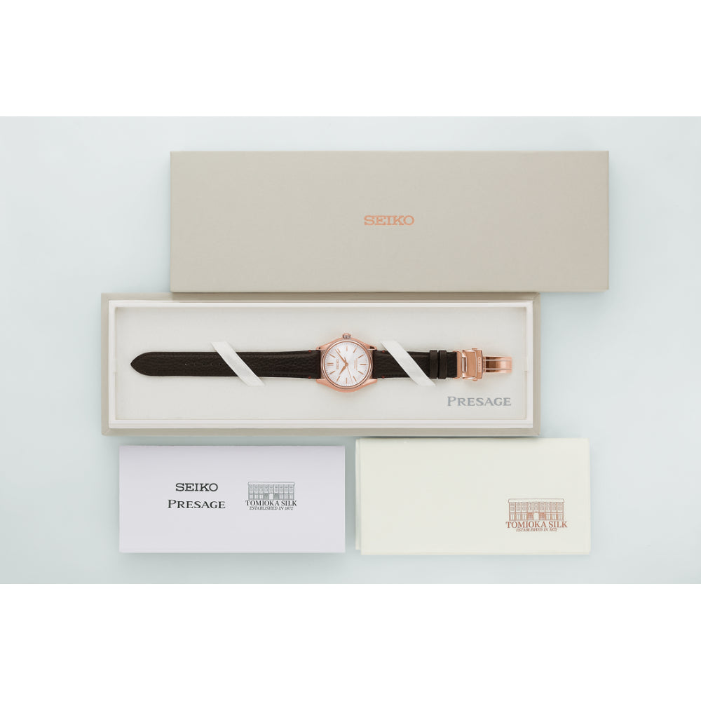 Seiko Presage watch with brown strap in a box on a light gray background