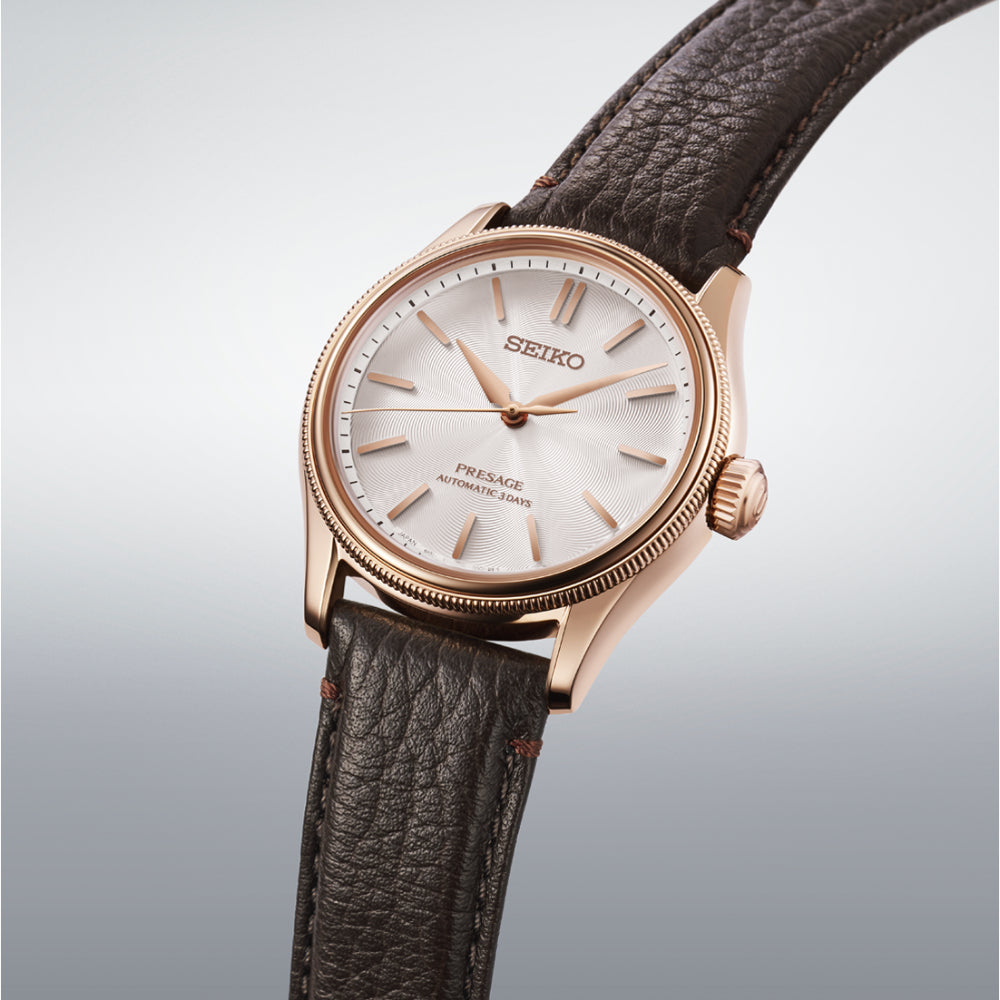 Seiko watch with brown leather strap on a light gray background
