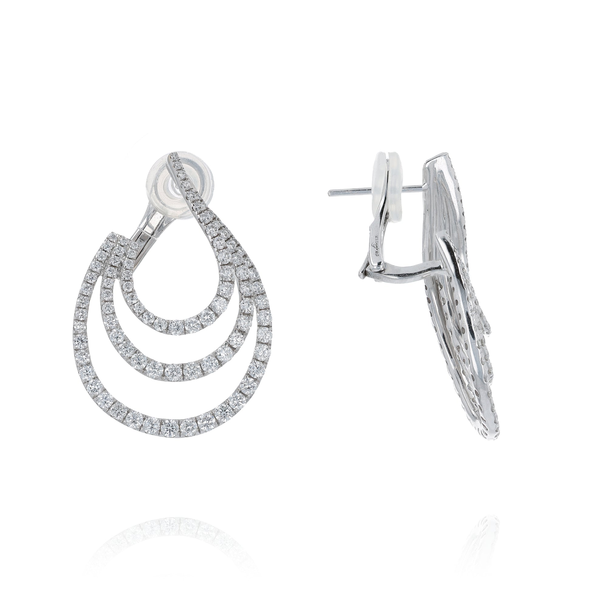 White gold 3 row diamond earrings on a white background