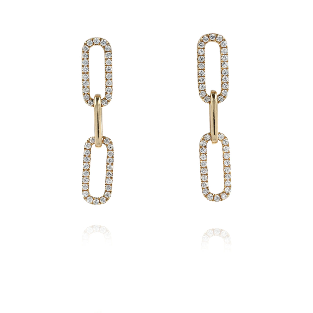 A pair of gold drop earrings with elongated oval links, each pavé-set with clear stones, shown on a clean white background with a soft reflection below.