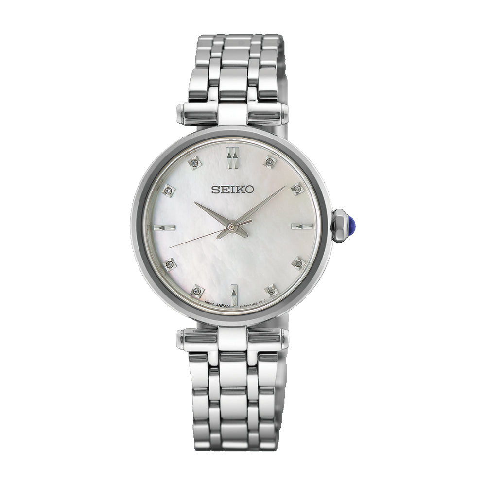 A Seiko women's watch featuring a silver stainless steel link bracelet, a round silver case, and a white mother-of-pearl dial with crystal hour markers and a blue cabochon crown.