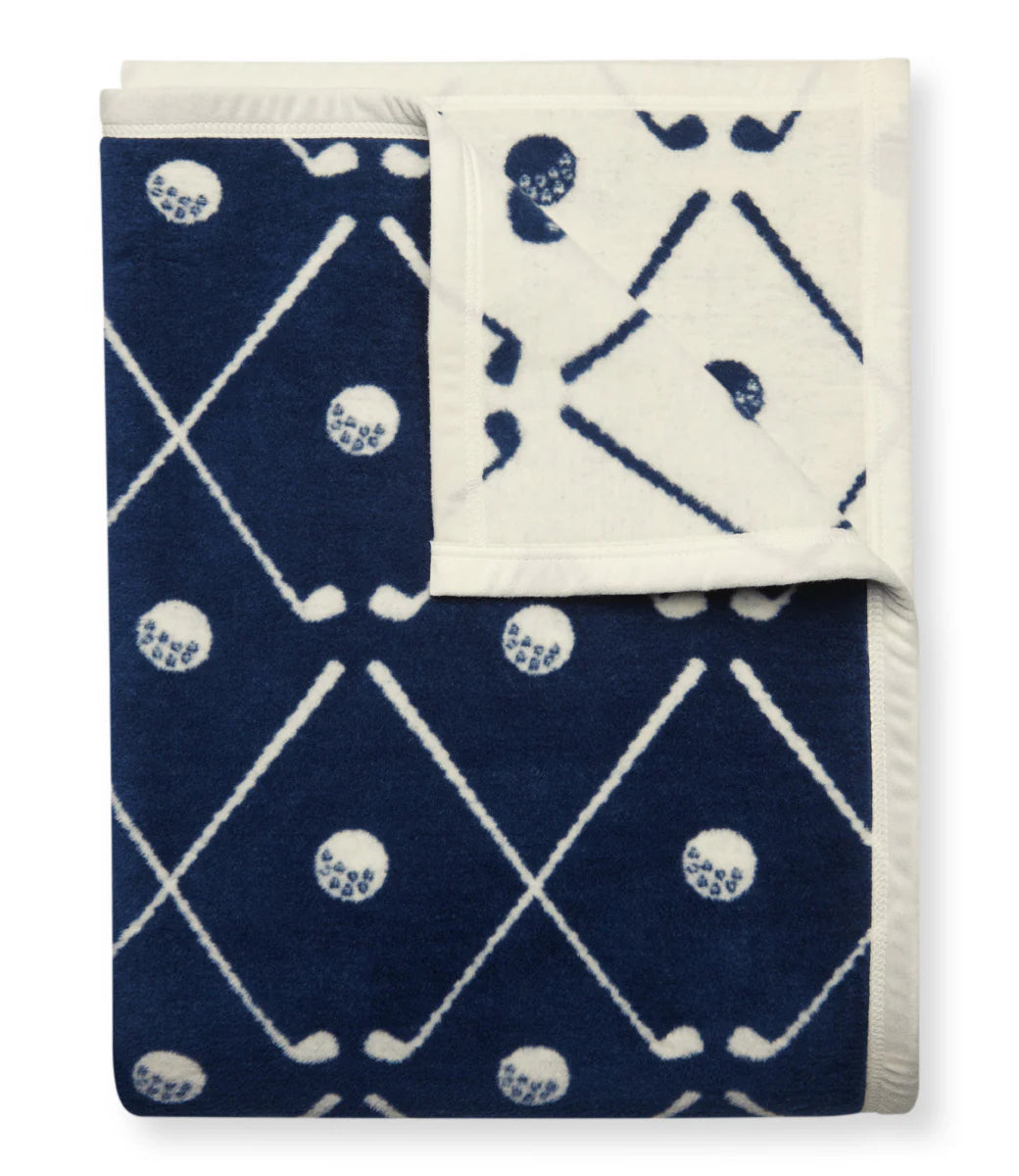 Folded blanket with blue and white geometric pattern with golf clubs on a white background