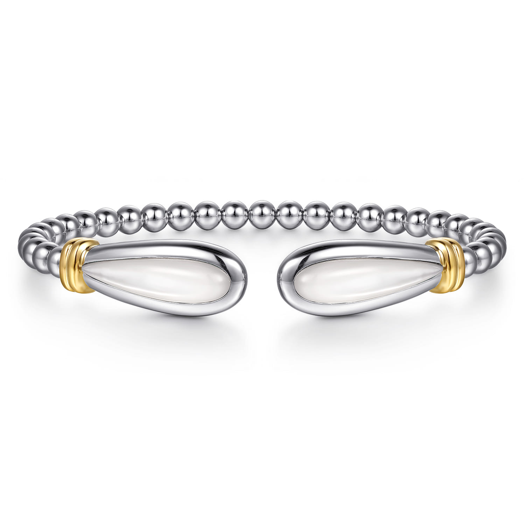Silver bracelet with gold accents on a white background