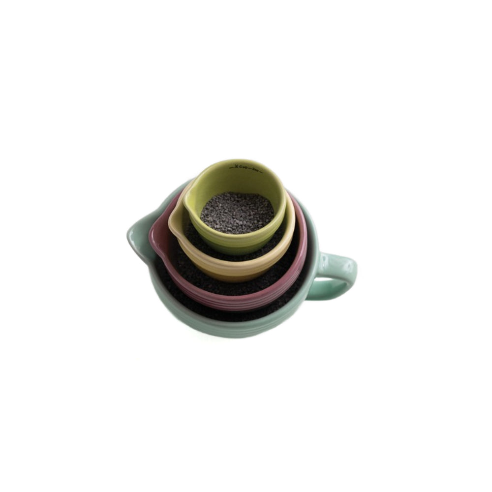 A top photo of a set of four stacked ceramic cups on a white background.