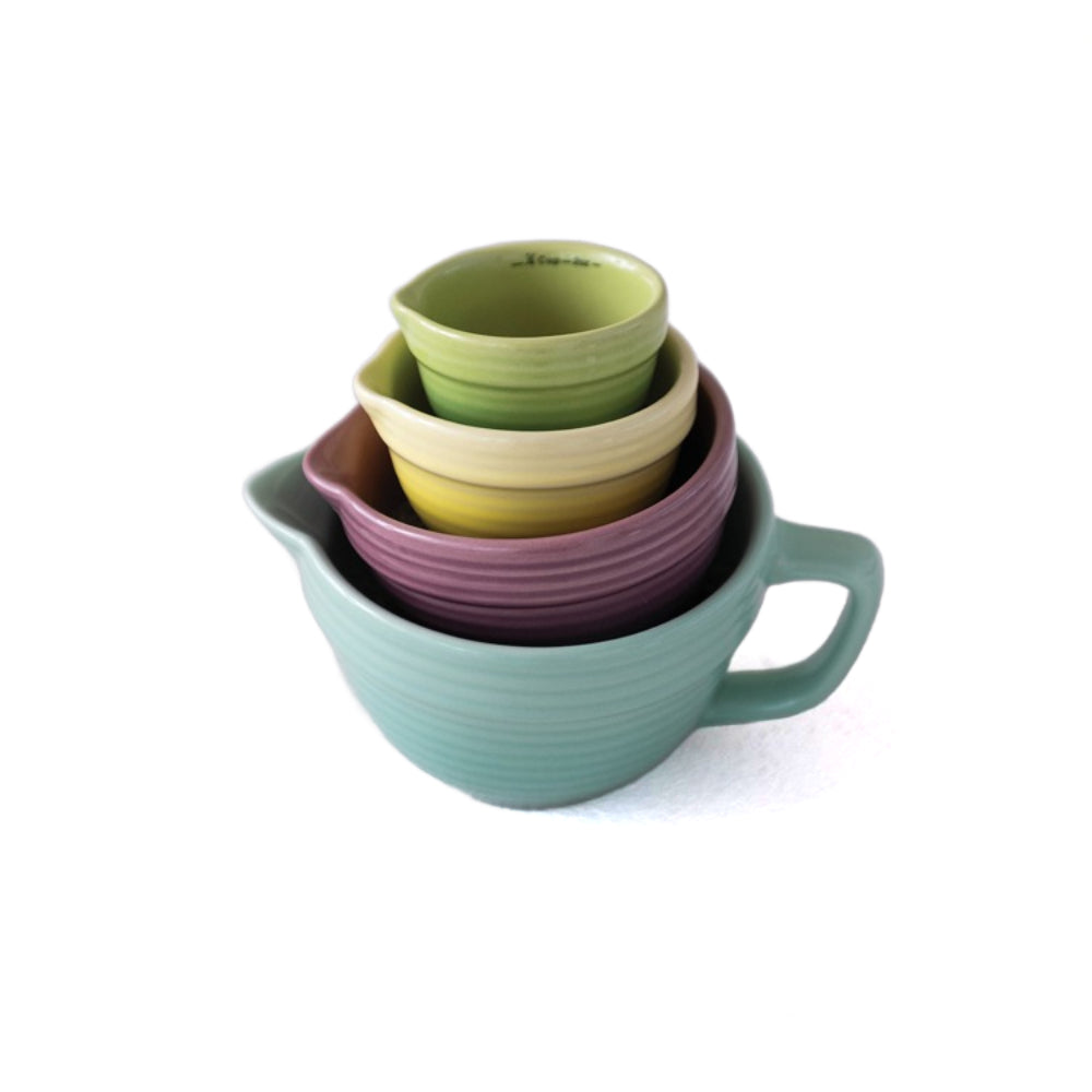A side photo of a set of four stacked ceramic cups on a white background.