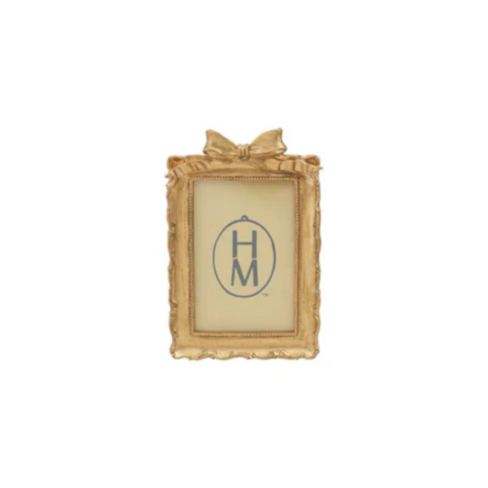 Rectangler decorative gold frame with a gold bow on top on a white background.