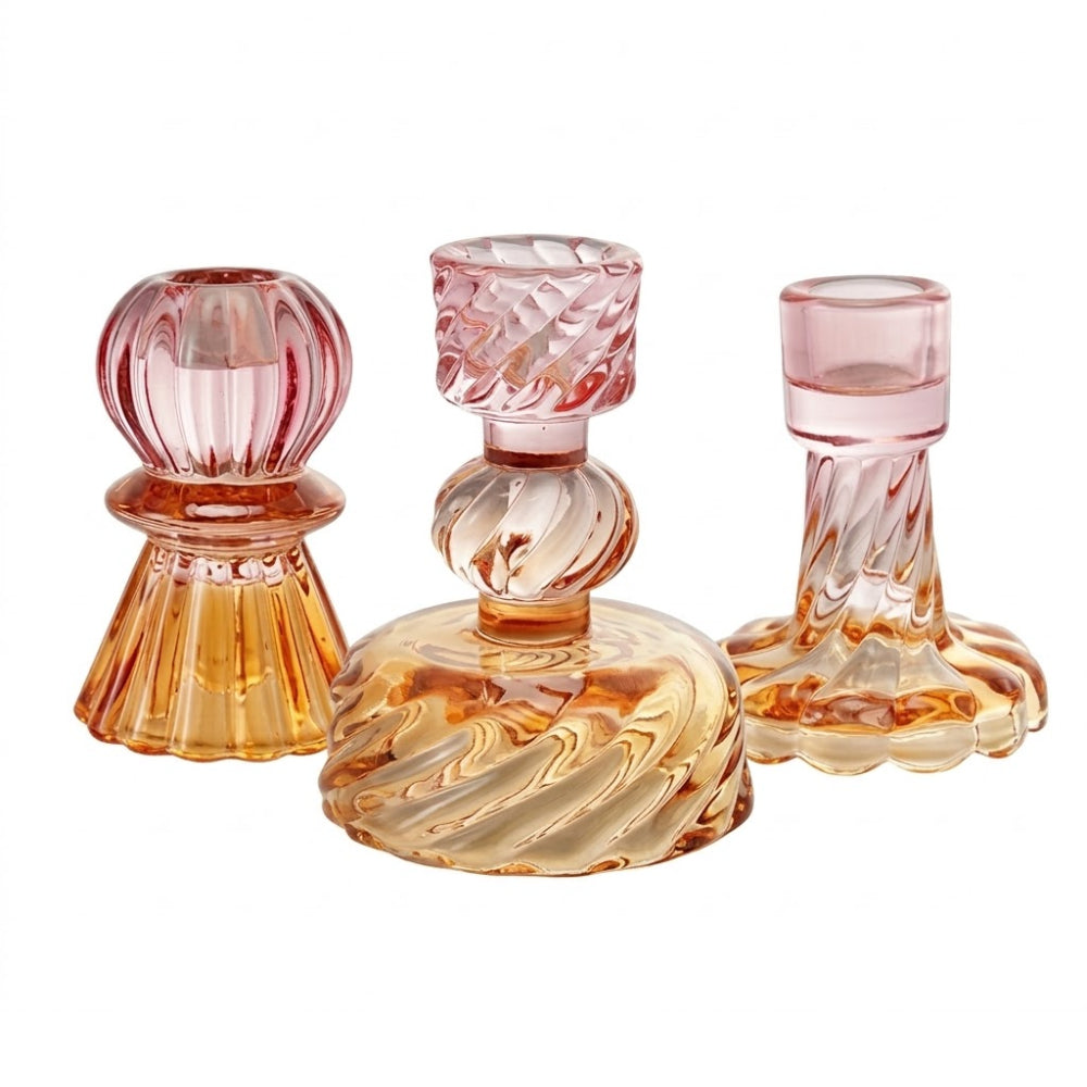 Three glass candle holders with pink and orange swirl patterns on a white background.