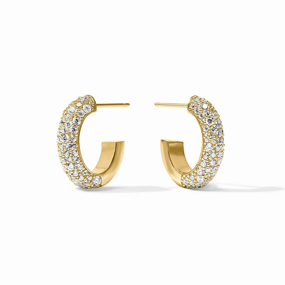 A pair of gold hoop earrings paved with clear cubic zirconia stones, shown on a clean white background.