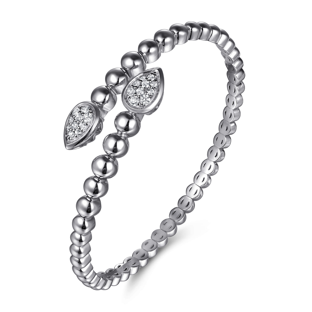 Silver beaded ring with diamond accents on a white background