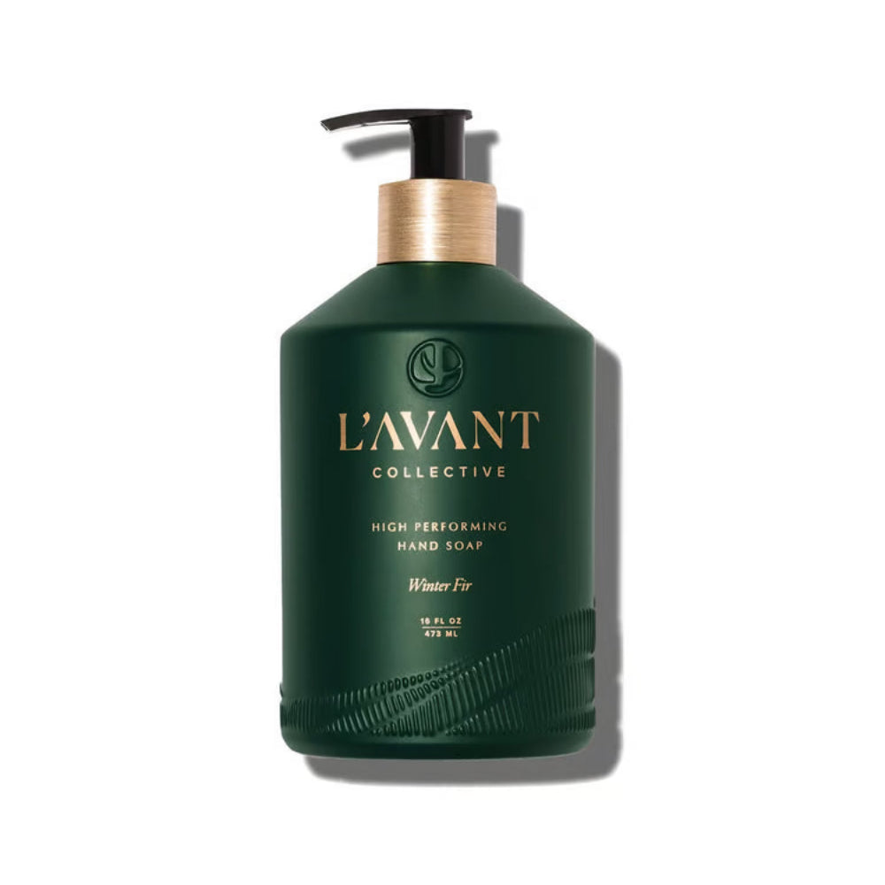 A dark green pump bottle of L'Avant Collective Winter For hand soap, featuring a metallic gold neck collar and a black pump dispenser, set against a plain white background with a soft shadow.