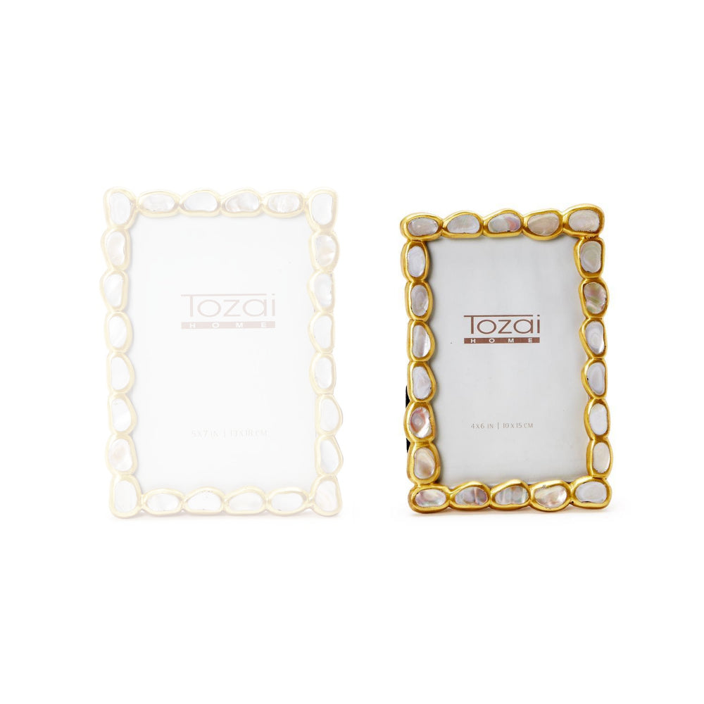  A 4x6 gold frame with a white mother-of-pearl inlay on a white backround. 