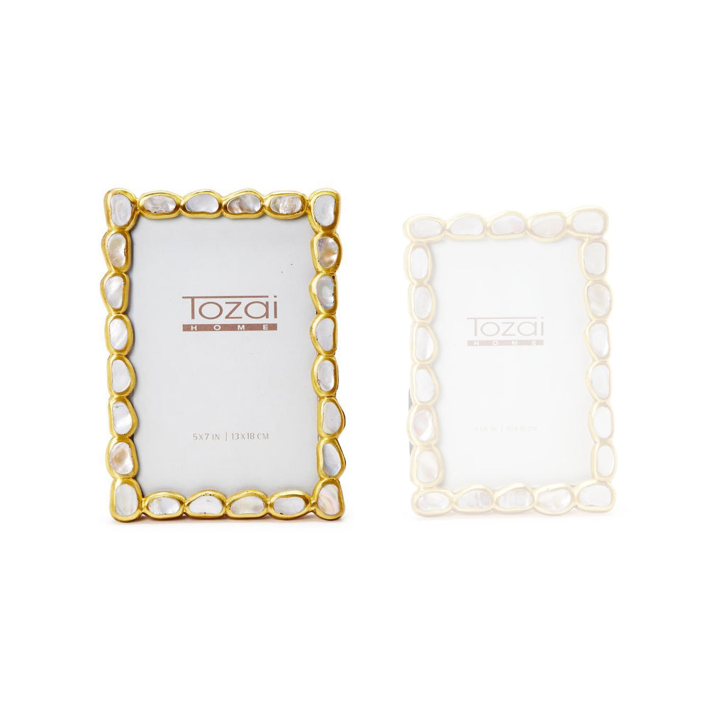  A 5x7 gold frame with a white mother-of-pearl inlay on a white backround. 