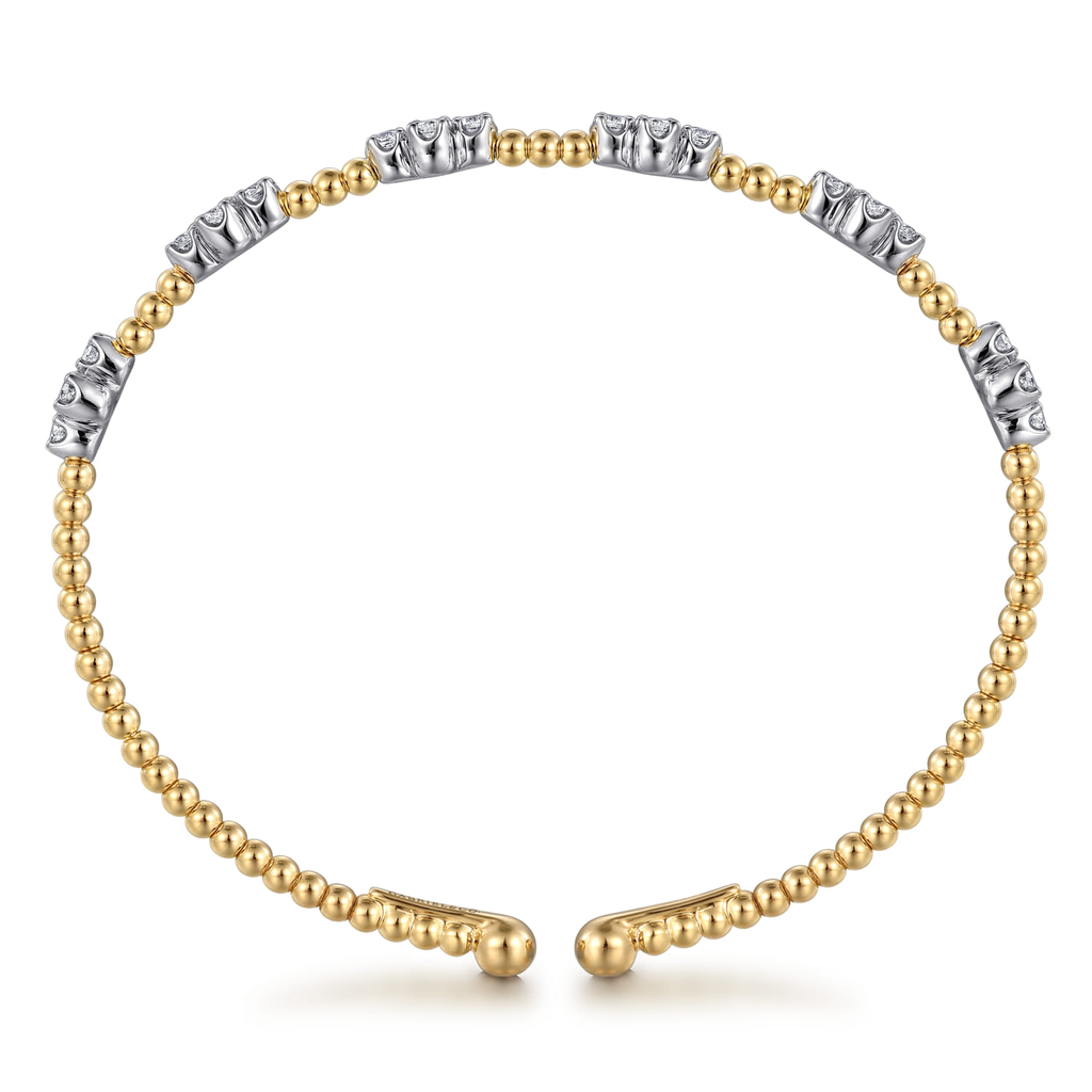 gold beaded bangle bracelet with clear stones on white background