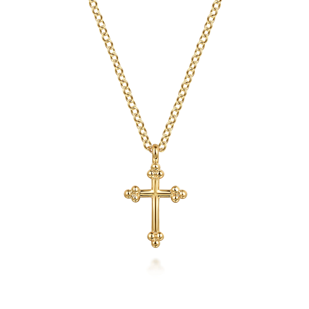gold cross pendant necklace on white background