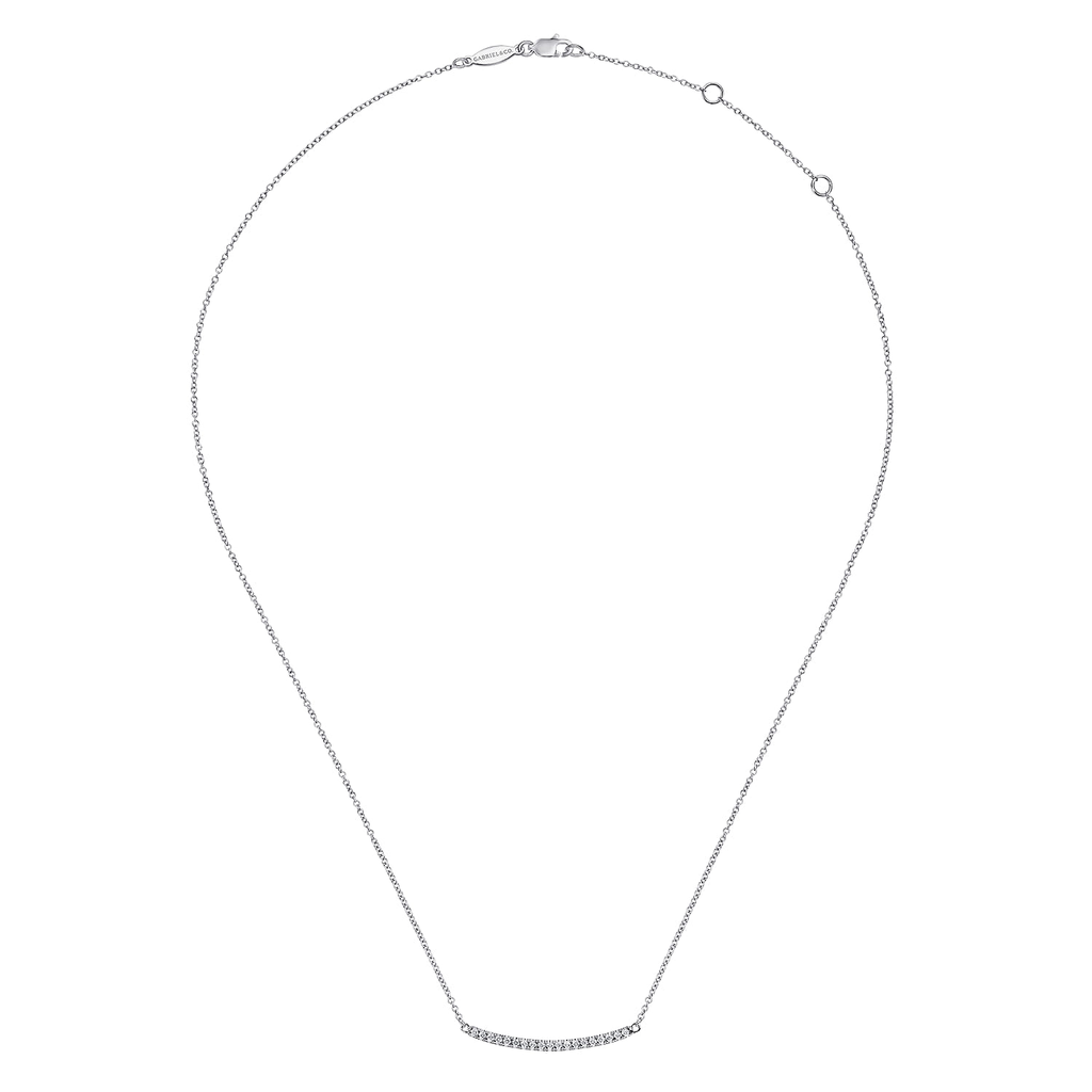 silver necklace with clear stones on white background