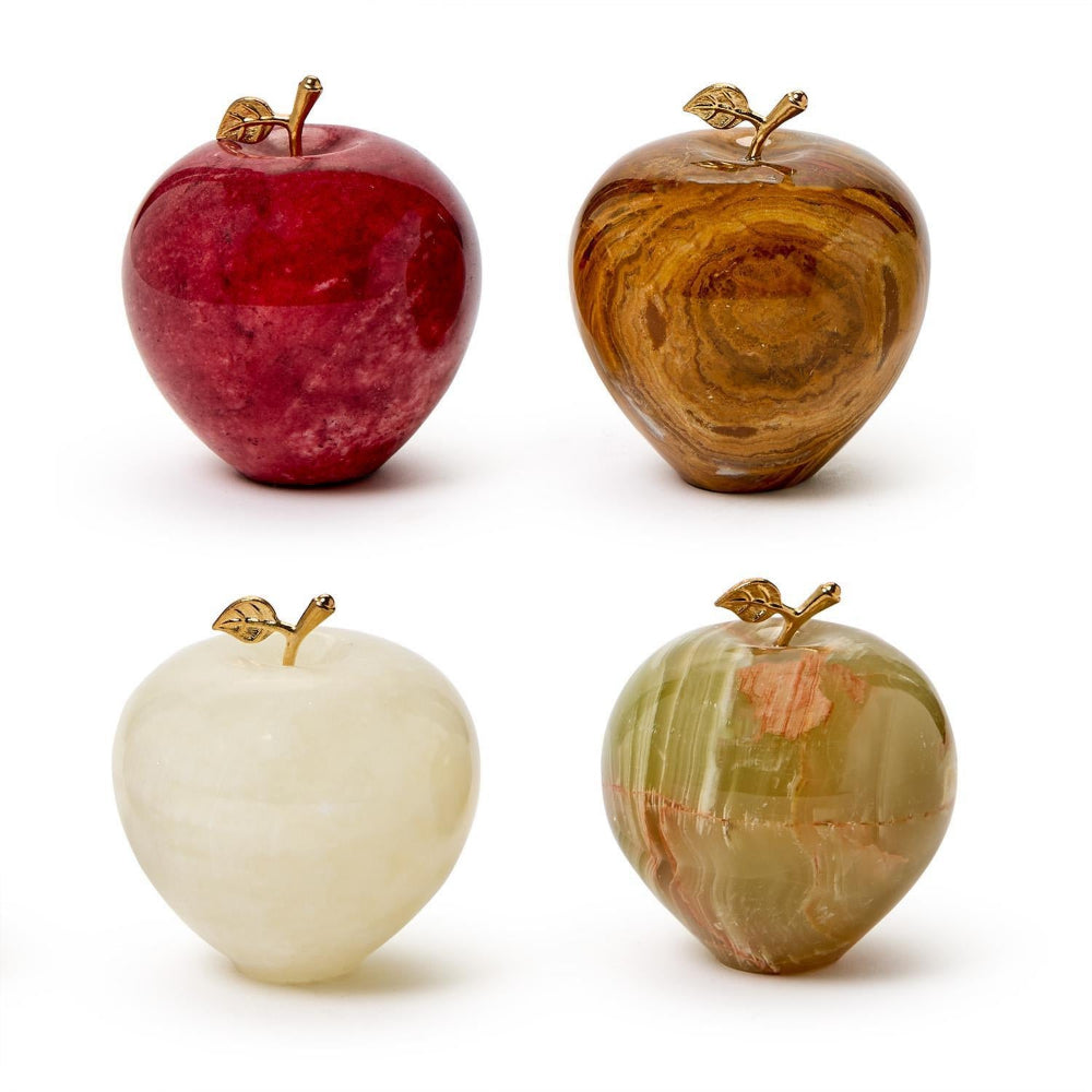 Four decorative apples in different colors on a white background