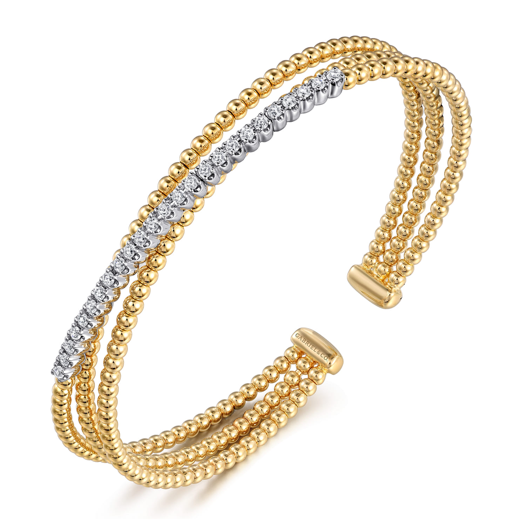gold and silver wrap beaded bracelet with clear stones on white background