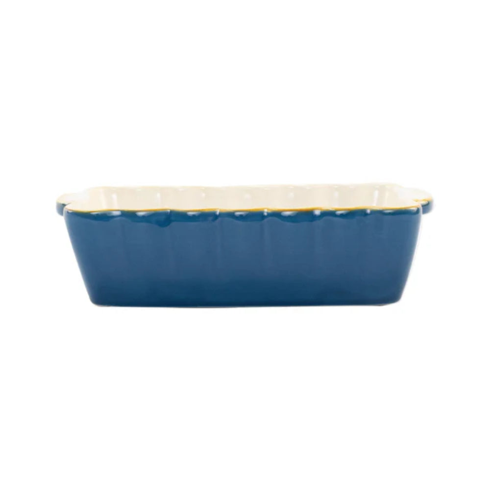 Blue rectangular ceramic dish with scalloped edge on a white background