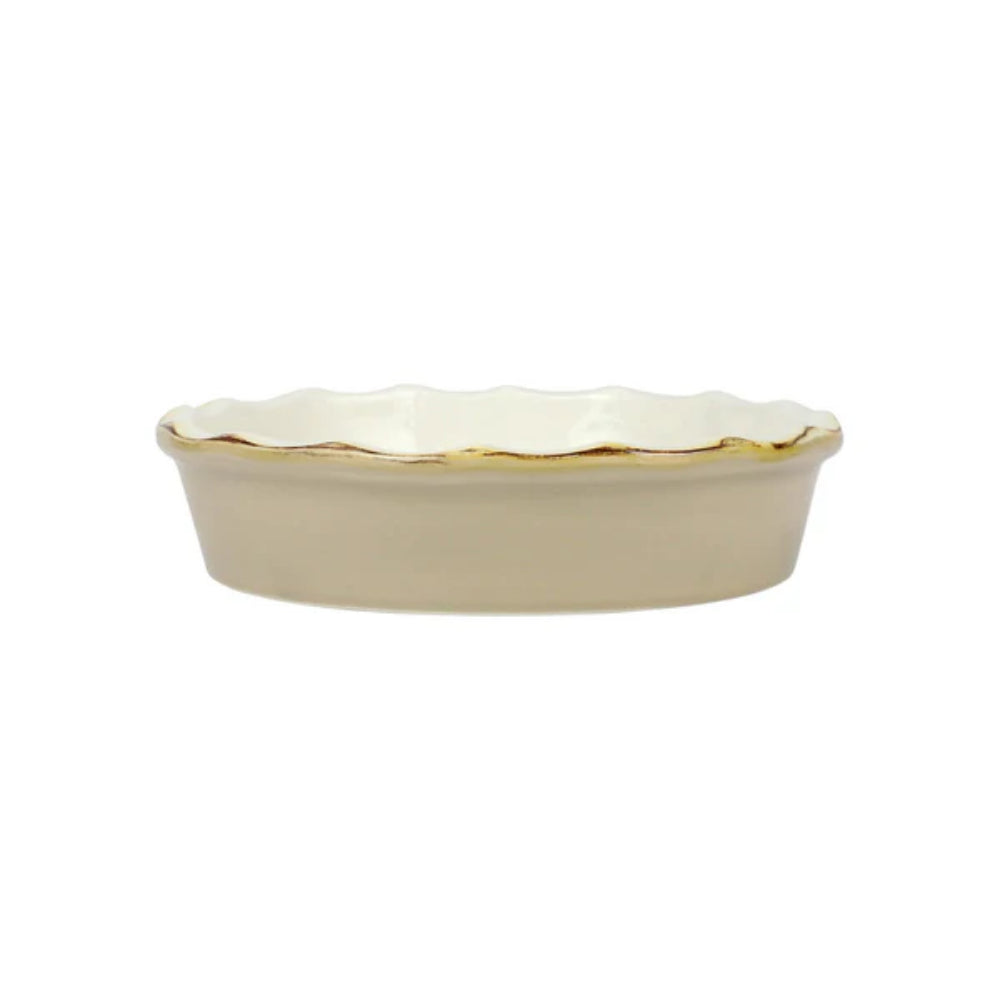 Beige ceramic dish with scalloped gold edge on a white background