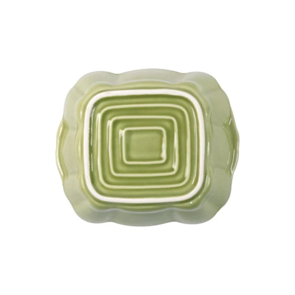 Green ceramic bowl with concentric square design on a white background