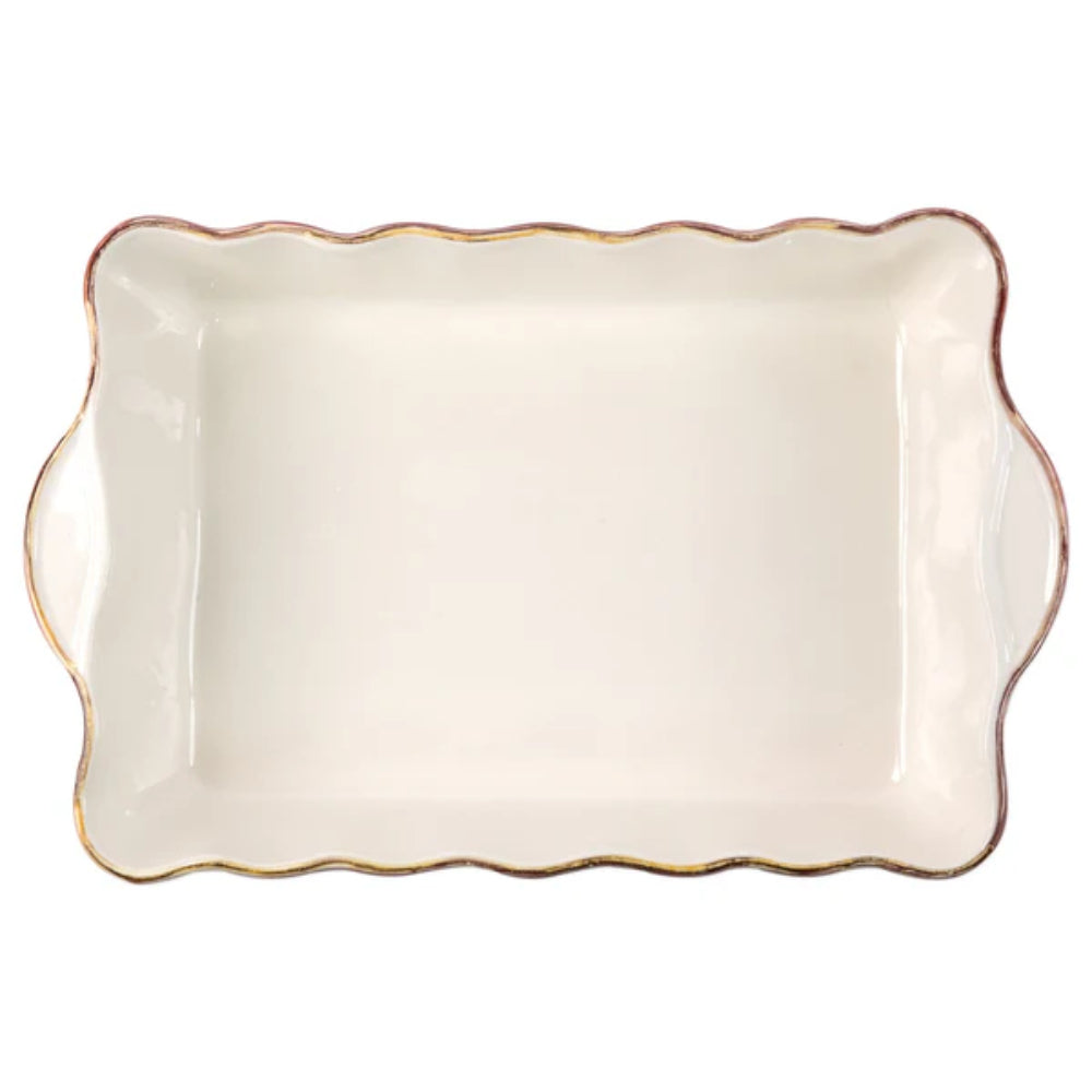 Top photo of a large  rectangular baking dish with a scalloped edge and gold rim with a white intior on a white background