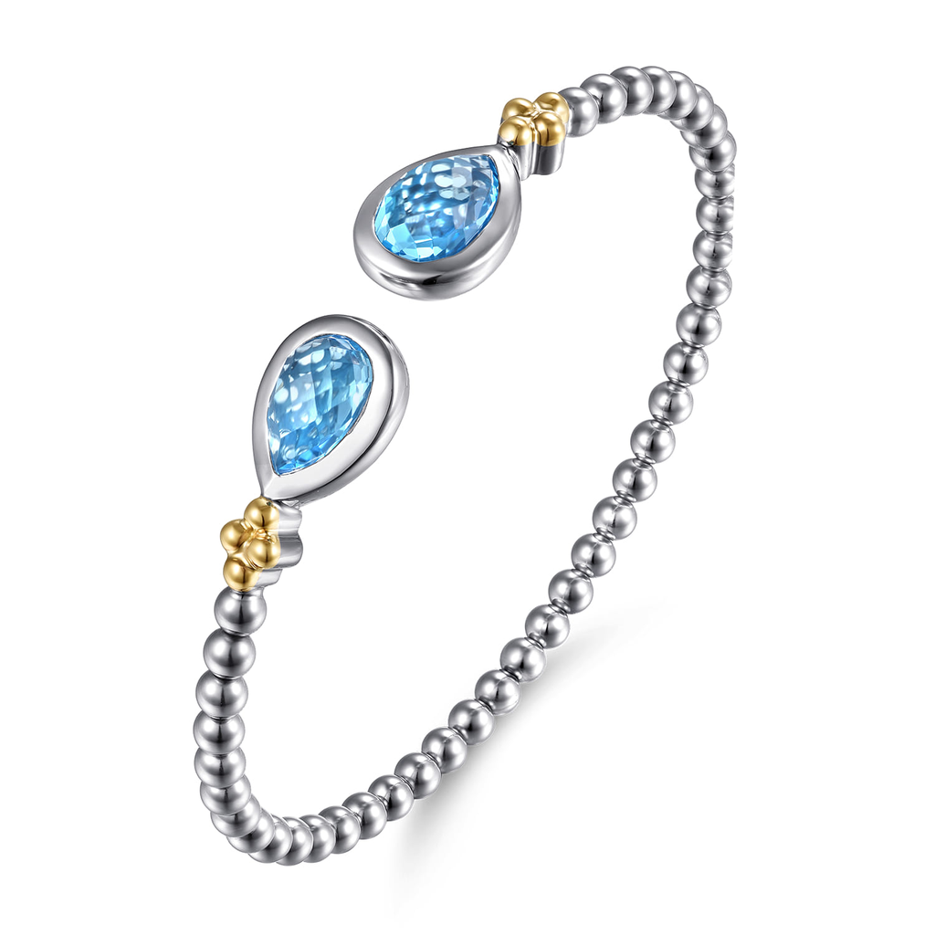 Silver bracelet with blue teardrop stones on a white background